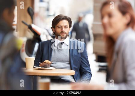 Contemplating deadlines. A thoughtful businessman sitting at a coffee shop in the city. Stock Photo