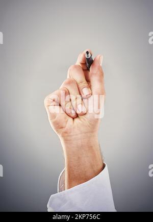 Leave your digital fingerprint. a hand holding a marker against a gray background. Stock Photo