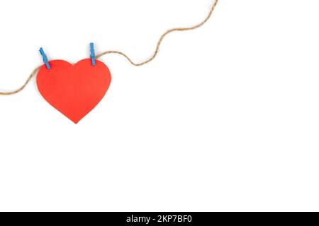 Heart made of paper on clothespins on a white background, isolated. Stock Photo