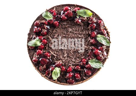 Chocolate cherry cake decorated with mint leaves on an isolated white background - Top of view. Stock Photo