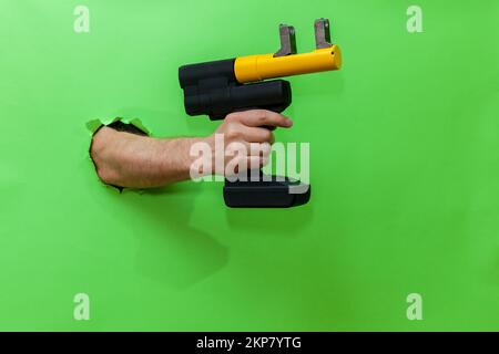 Hand press in male hand isolated on green Stock Photo