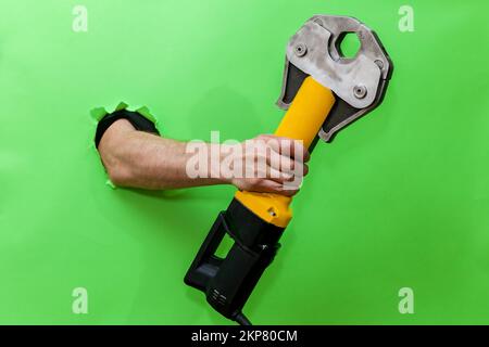Hand press in male hand isolated on green Stock Photo