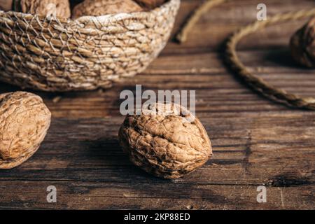 Close-up, whole walnuts on a wooden background, rustic style. Stock Photo