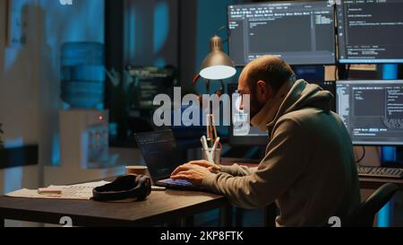 Male web developer with medical neck collar programming code in office ...