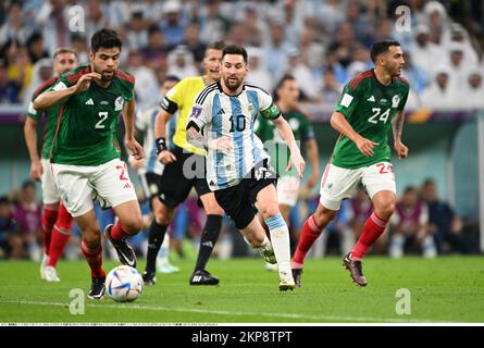 Lionel Messi (10) of Argentina and Nestor Araujo (2) and Luis Chavez (24) of Mexico during the FIFA World Cup Qatar 2022 Group C soccer match between Argentina 2-0 Mexico at Lusail Iconic Stadium on November 26, 2022, in Lusail, Qatar. (Photo by Takamoto Tokuhara/AFLO) Stock Photo