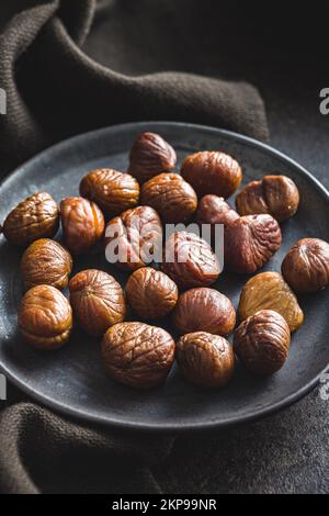 Peeled chestnuts. Sweet roasted chestnuts on the plate. Stock Photo