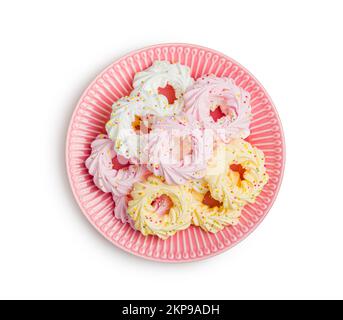 Different colors meringues with sprinkles isolated on the white background. Stock Photo