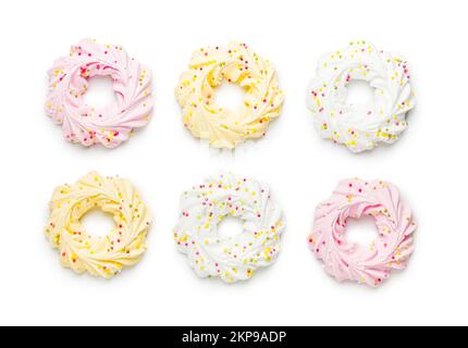 Different colors meringues with sprinkles isolated on the white ...
