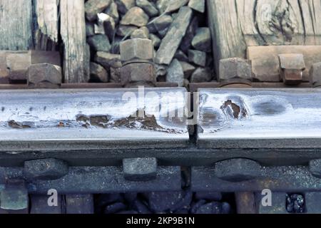 Wear and corrosion of steel rails at the junction (expansion gap), not wearing depth of rail head, flattening of rail. Railway business Stock Photo