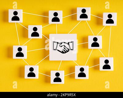 Business agreement between different parties. Business deal, cooperation and partnership network. Consensus. Cubes with network of employees and hands Stock Photo