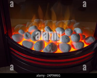 Close up of a lit coal effect electric fire in a UK house. Concept for keeping warm in winter Stock Photo