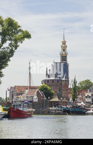 Editorial: HOORN, NORTH HOLLAND, NETHERLANDS, JULY 12, 2022 - The inner harbor of Hoorn with the Hoofdtoren. The Hoofdtoren is a medieval defense towe Stock Photo