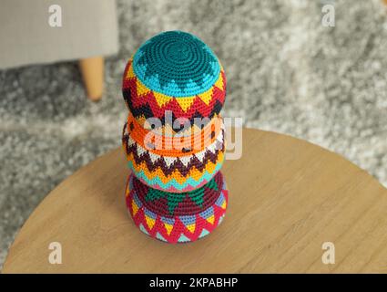 Close up of three colorful crocheted juggling balls on a round table Stock Photo