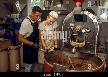 Professional roasters overseeing the coffee roasting process Stock Photo