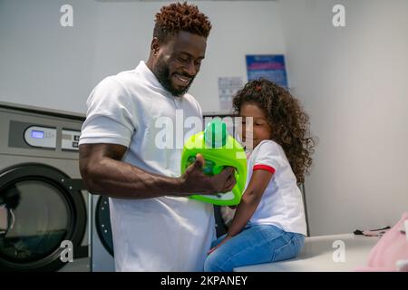 Family of two in the laundry room Stock Photo