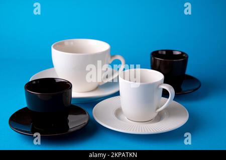 photo of many cups on saucers on blue background Stock Photo