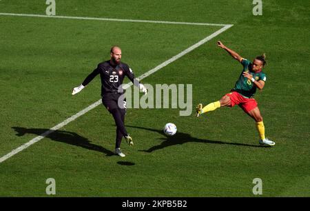 Serbia goalkeeper Vanja Milinkovic-Savic clears the ball under pressure from Cameroon's Pierre Kunde during the FIFA World Cup Group G match at the Al Janoub Stadium in Al Wakrah, Qatar. Picture date: Monday November 28, 2022. Stock Photo