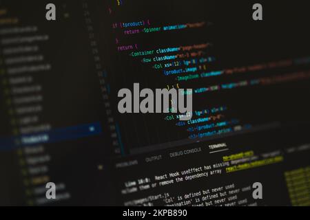 Programming language on black screen background, Javascript React code Stock Photo