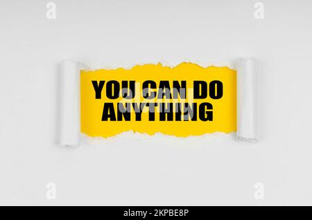 Education concept. A window is made in the paper, where on a yellow background the inscription - You Can Do Anything Stock Photo