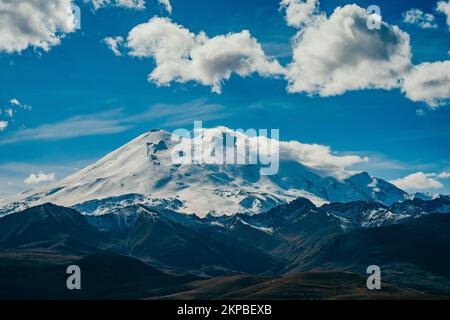 Big mountain Elbrus. Snow covered Greater Caucasus mountains. The two peaks of Mount Elbrus . Europe's highest peak. Journey to Kabardino-Balkaria. Russia. Stock Photo