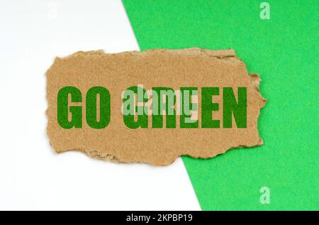 Environmental concept. On a white-green background lies a piece of cardboard with the inscription - Go Green Stock Photo