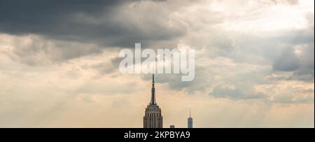 Skyscraper lightning rod on cloudy rainy sky panorama with low hanging clouds Stock Photo