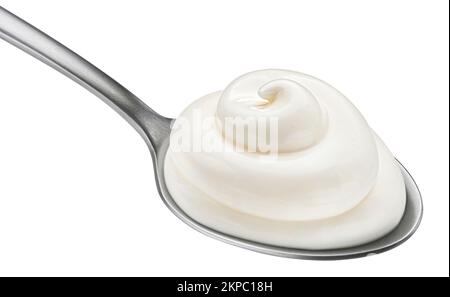 Sour cream in spoon isolated on white background Stock Photo