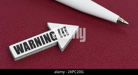 Business and finance concept. On a red background lies a white pen and a white arrow with the inscription - WARNING Stock Photo