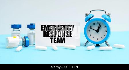 Medicine and health concept. An alarm clock, pills, injections and a card with the inscription - Emergency Response Team Stock Photo