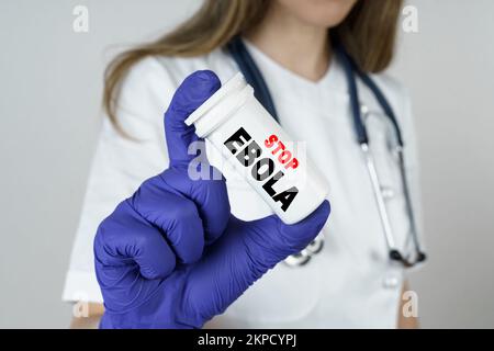 Medicine and health concept. The doctor holds a medicine in his hands, which says - STOP EBOLA Stock Photo