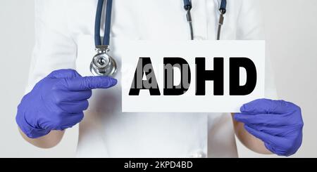 Medicine and health concept. The doctor points his finger at a sign that says - ADHD. Attention deficit hyperactivity disorder Stock Photo