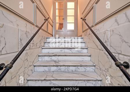 White Marble stairs in renovated mansion stairwell. Horizontal and Light on Stock Photo
