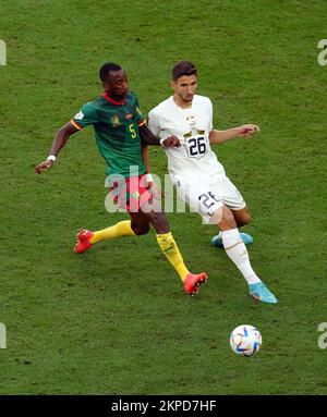 Cameroon's Gael Ondoua and Serbia’s Marko Grujic (right) battle for the ball during the FIFA World Cup Group G match at the Al Janoub Stadium in Al Wakrah, Qatar. Picture date: Monday November 28, 2022. Stock Photo