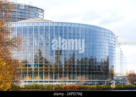 Strasbourg, France - Nov 22, 2022: Cars parked near European Parliament facade during 70 years of European democracy in action large banner on facade during ceremony marking the 70th anniversary Stock Photo