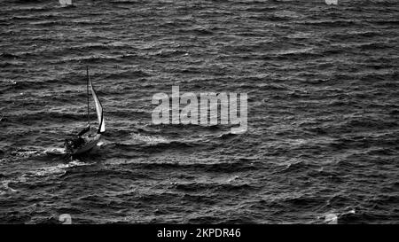 Cargo ship at sea. transit ship. Sailboats. Fishing boat. Fishing. Sightseeing Boat. Boat, ship floating in blue waters. Sunburns and ship reflecting Stock Photo