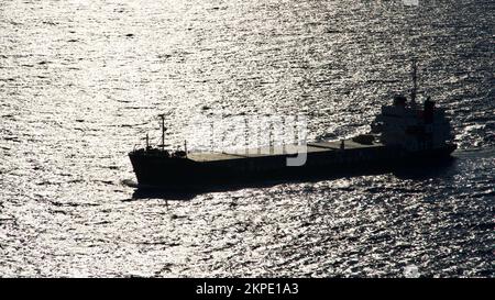 Cargo ship at sea. transit ship. Sailboats. Fishing boat. Fishing. Sightseeing Boat. Boat, ship floating in blue waters. Sunburns and ship reflecting Stock Photo