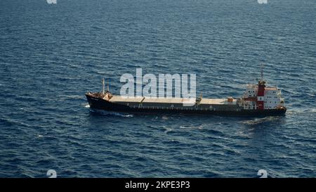 Cargo ship at sea. transit ship. Sailboats. Fishing boat. Fishing. Sightseeing Boat. Boat, ship floating in blue waters. Sunburns and ship reflecting Stock Photo