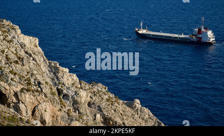 Cargo ship at sea. transit ship. Sailboats. Fishing boat. Fishing. Sightseeing Boat. Boat, ship floating in blue waters. Sunburns and ship reflecting Stock Photo