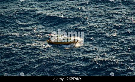 Cargo ship at sea. transit ship. Sailboats. Fishing boat. Fishing. Sightseeing Boat. Boat, ship floating in blue waters. Sunburns and ship reflecting Stock Photo