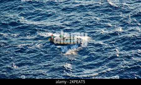 Cargo ship at sea. transit ship. Sailboats. Fishing boat. Fishing. Sightseeing Boat. Boat, ship floating in blue waters. Sunburns and ship reflecting Stock Photo