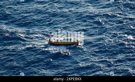 Cargo ship at sea. transit ship. Sailboats. Fishing boat. Fishing. Sightseeing Boat. Boat, ship floating in blue waters. Sunburns and ship reflecting Stock Photo