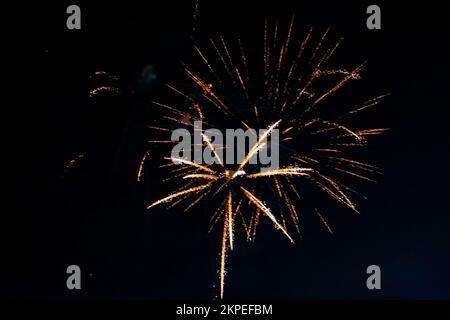 An explosion of bright single fireworks, against the background of the night sky. High quality photo Stock Photo