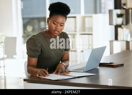 Black woman, finance paper and accounting worker, laptop and working on budget, planning and strategy in office at desk. Business woman, financial Stock Photo