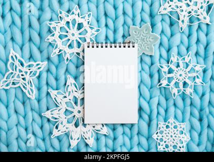 Above view of empty page of white paper notebook for making Christmas gifts wish list or write a letter to Santa Clause, Christmas commercial backgrou Stock Photo