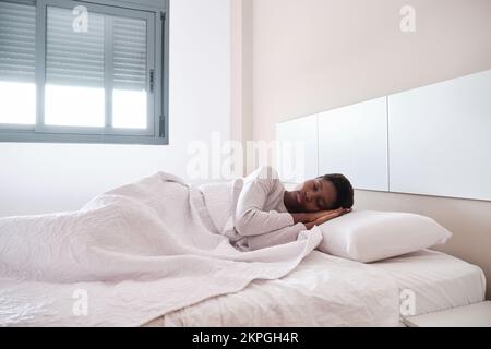 African American female having nap in bedroom Stock Photo