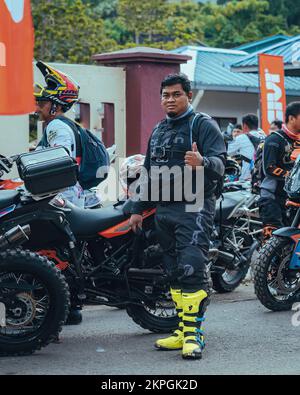 Pahang, Malaysia - Sept 24, 2022 Enduro motorcyclist giving thumbs up at the starting point during practice. Stock Photo