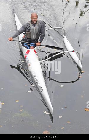 Aerial view man canoeist paddling in Italian Allwave Vanguard outrigger canoe along still waters of River Can in City of Chelmsford Essex England UK Stock Photo