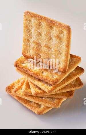 A pile of seven sugar-coated sweet crackers with one standing on top Stock Photo