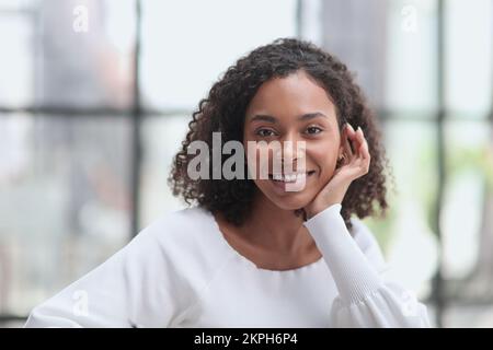 Happy business woman smiling inside office building Stock Photo