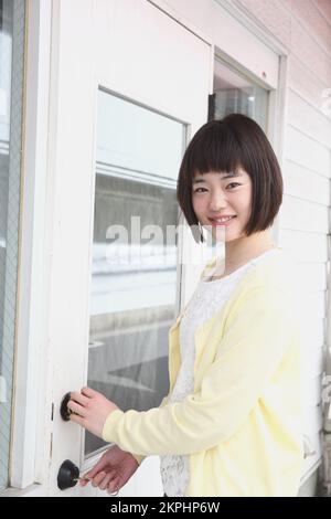 Young Japanese woman heading out Stock Photo - Alamy